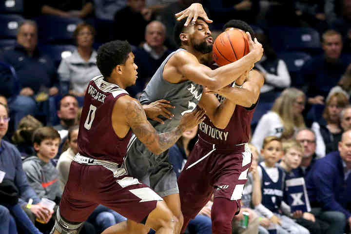 Xavier Musketeers guard Kyle Castlin (2) maintains possession as Eastern Kentucky's Dujuanta Weaver (left) and Jomaru Brown defend in the first half of a game at Cintas Center in Cincinnati.